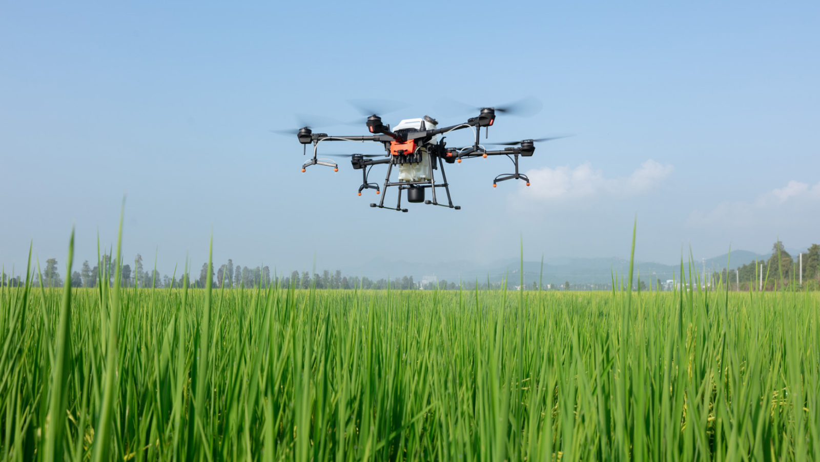 Professional drone flying over agricultural landscape showcasing precision aerial technology and surveying capabilities